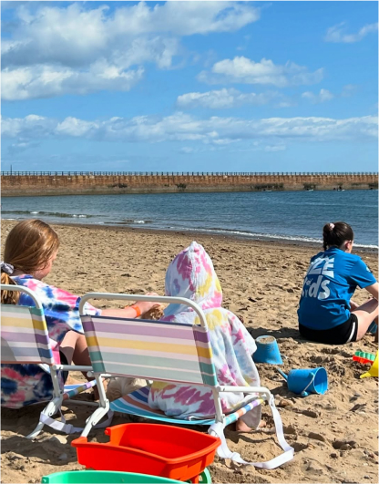 family sitting on a beach