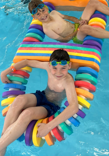 Two children playing in a pool